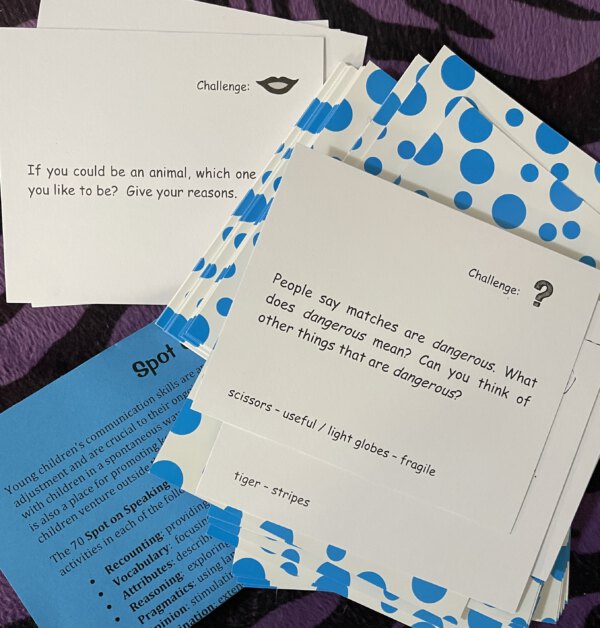 Challenge cards about animals and dangers on a table.